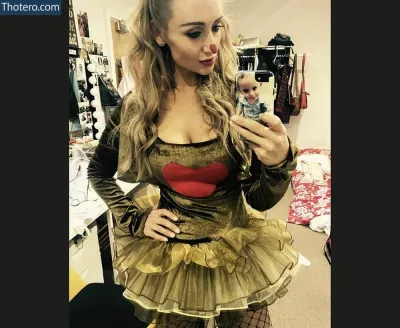Catherine Tyldesley - blond woman in a costume taking a selfie in a mirror