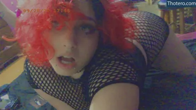 nymphofstyx - there is a woman with red hair and fishnets posing for a picture