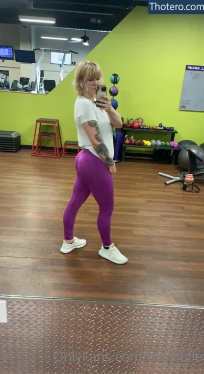 blissfulle - woman in purple leggings taking a selfie in a gym