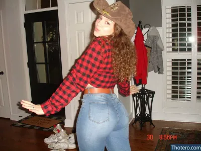 Mira.alifantis - woman in a cowboy hat and jeans posing for a picture